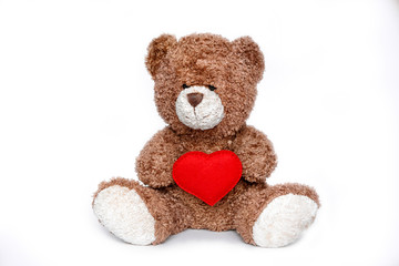 teddy bear holding heart on a white background isolated .