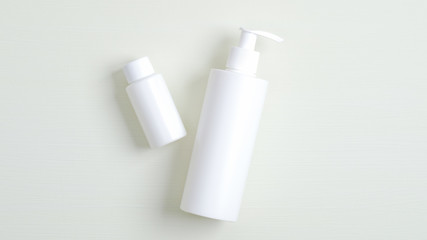 White plastic bottle with pump and essential oil for hair container branding mockup. Cosmetics SPA, shampoo and lotion packaging