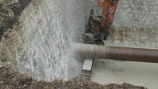 Horizontal drill rig cutting utilities tunnel into rock