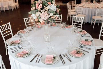 Festive table setting with a floral arrangement in the center and with a table number