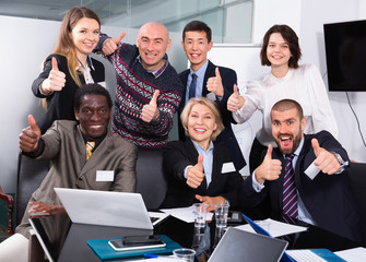 Portrait of happy successful multinational business group in meeting room