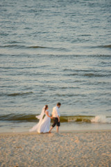 Bride and groom at a photo session in the nature. Baltic sea beach
