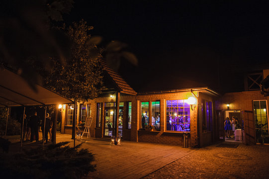 View of restaurants from outside at night. Wedding party