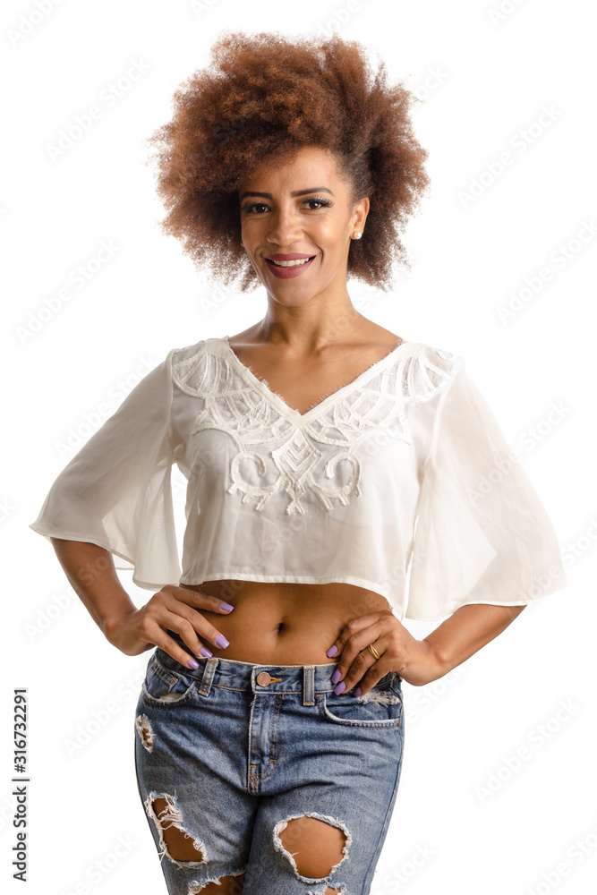 Wall mural curly hair afro descendant woman looking at camera with joyful smile. Standing against white background.