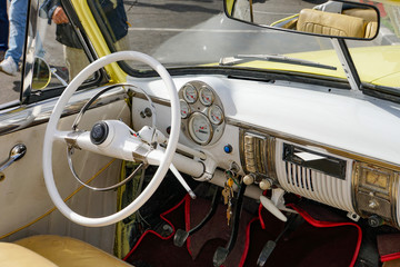 interior of a yellow cuban convertible classic car, steering wheel, cuba	