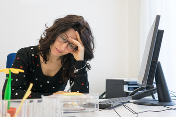 Stressed woman at work into office In front computer. Burn out concept