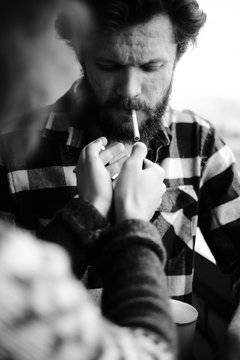 Man is lighting up friend's sigarette