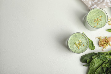 Flat lay composition with green buckwheat smoothie on white table, space for text