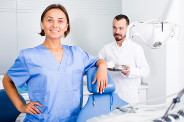 Dentist with assistant are fooling around in the workplace