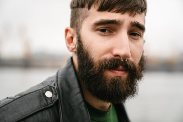 Fototapeta premium Photo closeup of bearded young man looking at camera