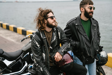 Fototapeta premium Photo of bearded caucasian men bikers talking while standing