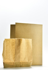 Two brown paper bags placed on a white background