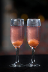 Two glasses of pink champagne for the couple.