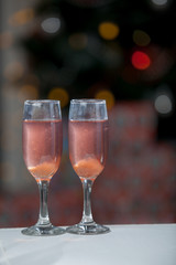 Two glasses of pink champagne for the couple.