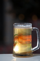 Mug of beer on wooden background