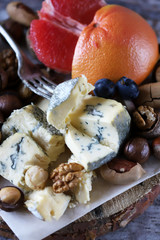 Mix of cheeses, nuts and fruits. Healthy snack. Appetizer to wine. Selective focus.