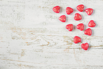 Wooden light background with red hearts. Valentine's day concept.