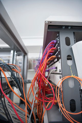 Multicolored data cable connected to computer network in server room
