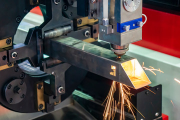 The fiber laser cutting machine cutting the stainless steel tube control by CNC program. The sheet...