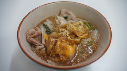noodles in gravy pork, fried eggs and vegetables