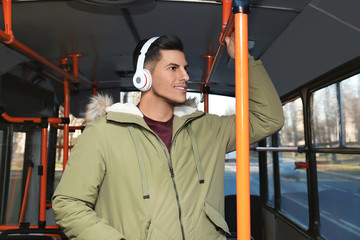 Fototapeta na wymiar Man listening to audiobook in trolley bus