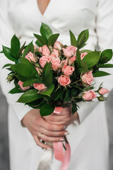 Bride with a bouquet in her hands, close-up