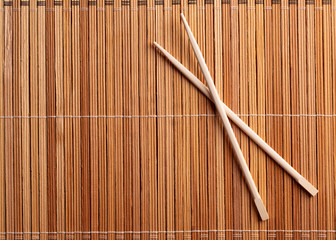 Two wooden chopsticks. Chopsticks on a wooden table surface close-up. Chopsticks on wooden background top view.