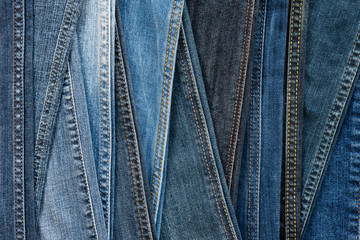Denim background. Blue jeans seams of different shades and textures.