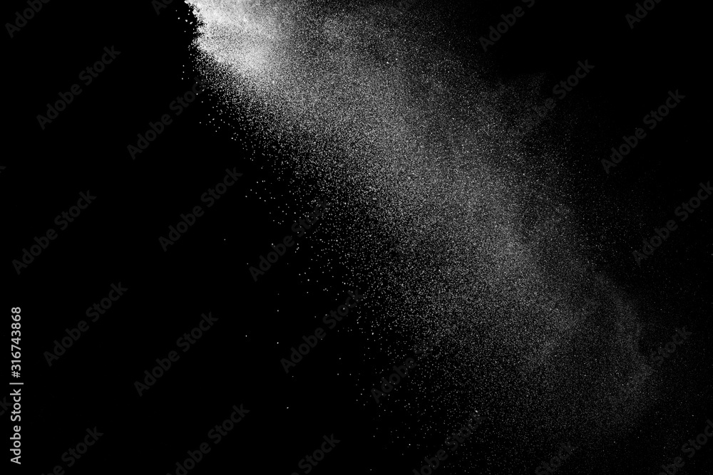 Wall mural freeze motion of white color powder exploding on dark background.