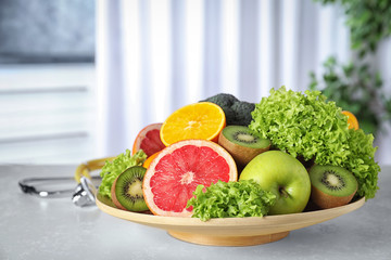 Plate of fruits on table. Diet plan from nutritionist