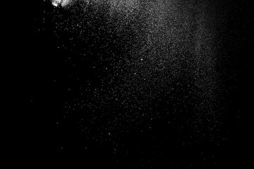 Freeze motion of white color powder exploding on dark background. 