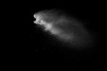 Fototapeta na wymiar Freeze motion of white color powder exploding on dark background. 