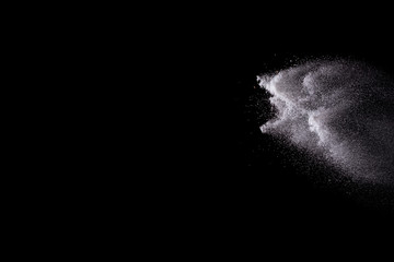 Fototapeta na wymiar Freeze motion of white color powder exploding on dark background. 