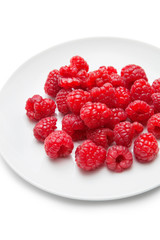 Fresh raspberries in plate against white background
