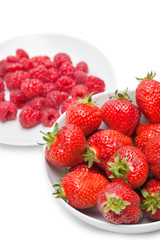 Strawberries and raspberries over white background