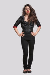 Full length portrait of a young woman against gray background