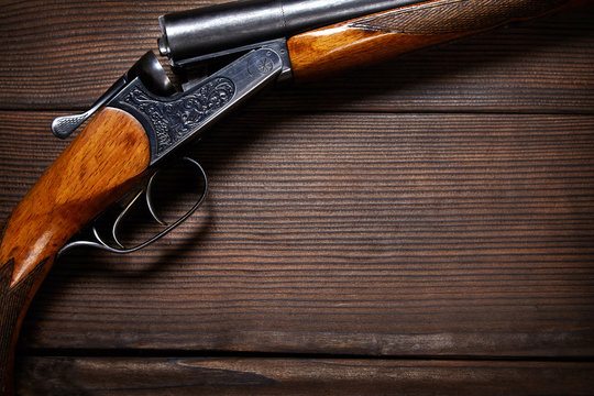 Vintage rifle on wooden background. Hunting concept.