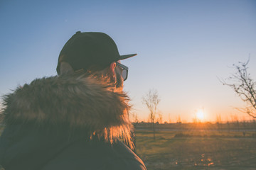 Caucasian boy looking at the sunset