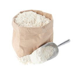 Paper bag and scoop with flour isolated on white