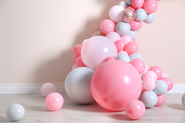 Beautiful composition with balloons near beige wall