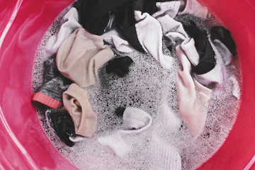 washing socks in plastic basin