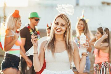 Brazilian Carnival. Group of Brazilian people celebrating the carnival party. The driver drinks water.