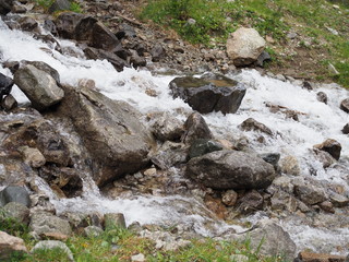 Close-up of a small waterfall in the forest in the mountains