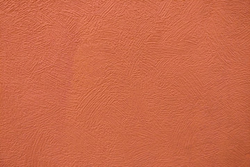 Fototapeta premium Surface background with smears of dark orange paint, close-up texture