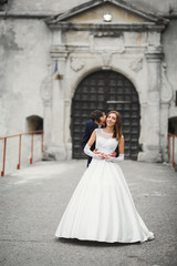 Fototapeta premium Romantic wedding moment, couple of newlyweds smiling portrait, bride and groom hugging