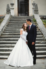 Fototapeta premium Romantic wedding moment, couple of newlyweds smiling portrait, bride and groom hugging