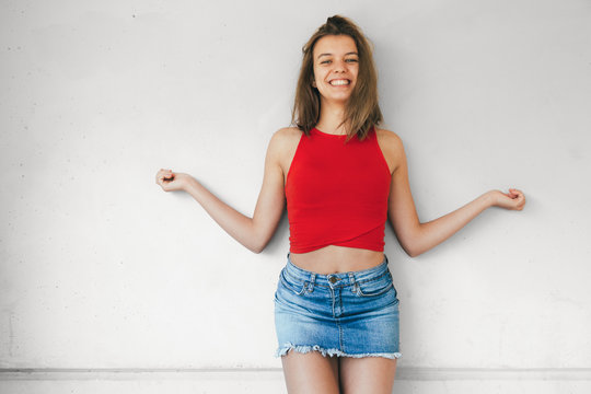 Cheerful teen girl laughing with open arms