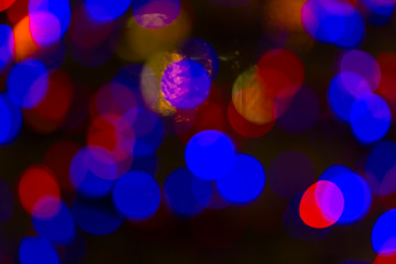 Bokeh and flare of blured background in nightclub. Fresh healthy blue red background with abstract blurred foliage and bright summer sunlight and a central copyspace for your text or advertismen