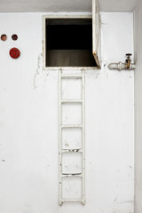 Metal ladder for climbing to the hatch of an apartment building
