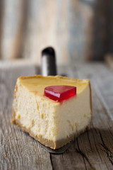 Delicious slice of new york cheesecake with word  on white background. Sweet and tasty food, coffee break concept. Classic american dessert.